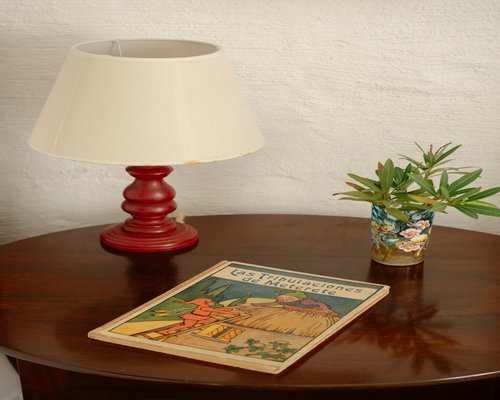 A bedside table with a warm lamp and a book ready for reading