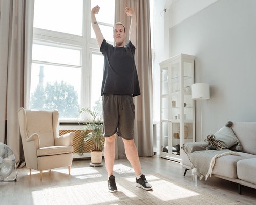 Simple stretching exercises done in a living room